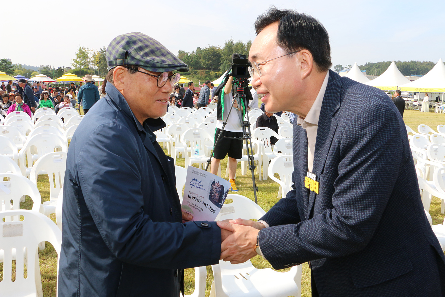 나주 금돈관 출토 기념 문화제 나주시장이 문화제에 참석한 남성 분과 악수를 나누며 인사를 하는 모습