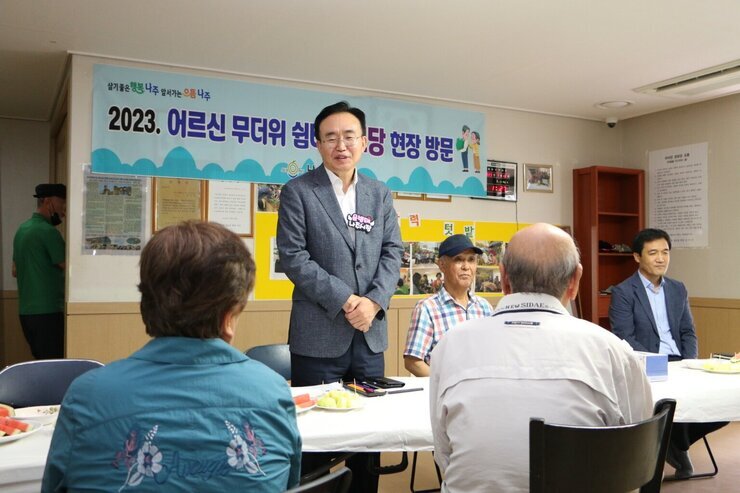 우미린 경로당 무더위 쉼터 방문 나주시장이 자리에 일어서서 어르신들께 인사말을 하고 있는 모습