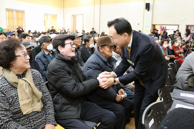 중부노인복지관 실버어울림 문화축제 자리에 앉아 있는남성 어르신과 나주시장이 활짝 웃으며 악수와 함께 인사를 나누는 모습