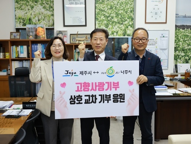 제주시-나주시 고향사랑기부 상호 교차 기부 응원 이라고 적힌 팻말을 들고 화이팅 포즈로 촬영하는 사진